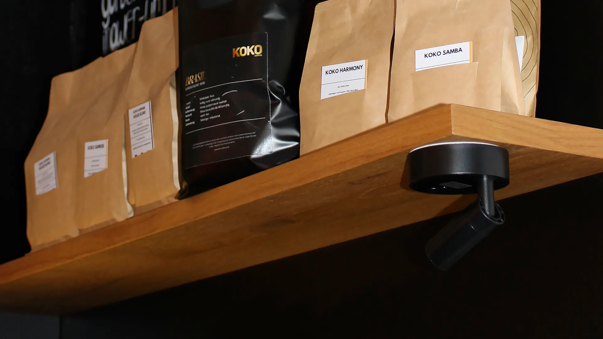Shop shelf with KOKO Brasil, Harmony and Samba bean bags and colorful row of ceramic cups below